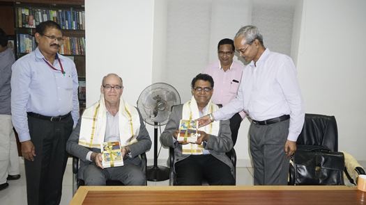 Vasireddy Vidyasagar felicitating Prof. Gregory Collier and Krishna P Nangegadda min